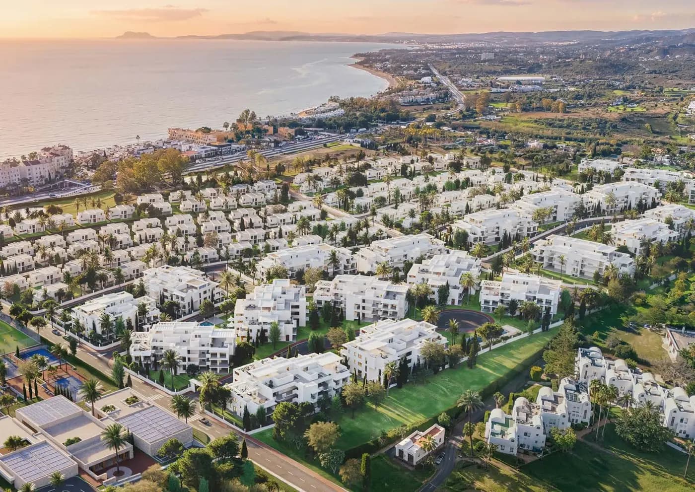 Brochure aerial illustration of the full Royal Park urbanisation looking towards the Mediterranean Sea, with residential blocks, gardens and resort facilities